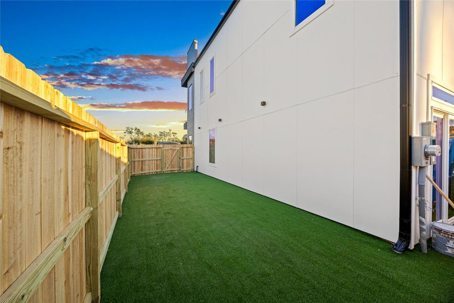 Yard at dusk with a fenced backyard