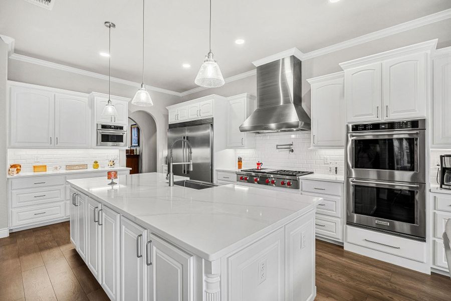 A well-appointed culinary space featuring gleaming stainless steel appliances and a spacious center island. A well-appointed culinary space featuring gleaming stainless steel appliances and a spacious center island.