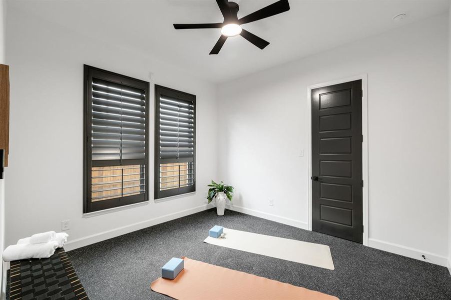 Workout area with carpet flooring and a ceiling fan Workout area with carpet flooring and a ceiling fan