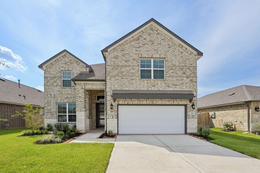 Front exterior of a new home in Kingdom Heights, Rosenberg, TX, highlighting curb appeal (Image 2). Front exterior of a new home in Kingdom Heights, Rosenberg, TX, highlighting curb appeal (Image 2).