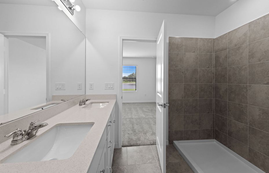 Owner's bathroom with dual-sink vanity and spacious shower Owner's bathroom with dual-sink vanity and spacious shower