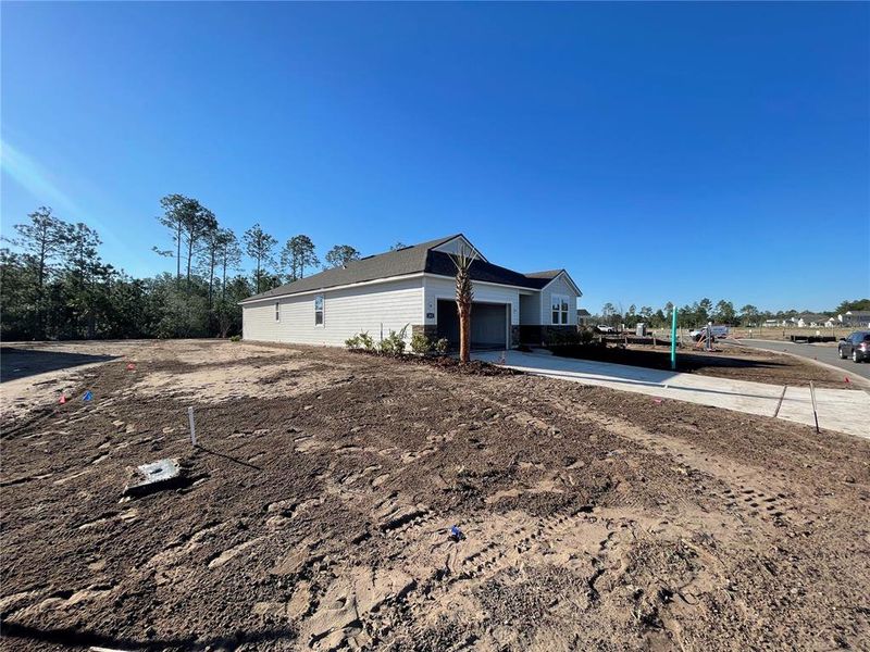 Front exterior of a new home in Magnolia Series at Seminole Palms, Palm Coast, FL, highlighting curb appeal (Image 16).