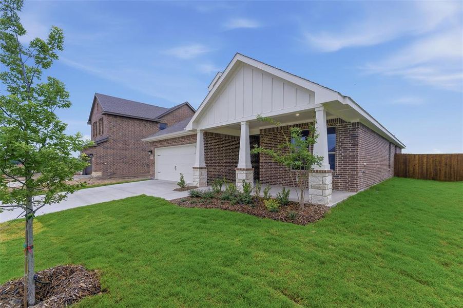 Brick exterior with stone accents and a covered front porch