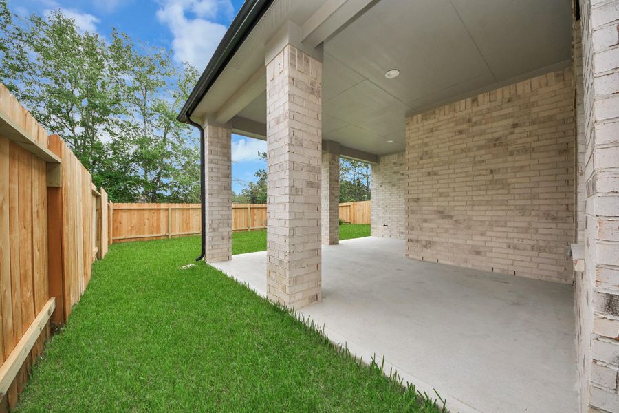 Experience outdoor living at its finest on this expansive covered patio, thoughtfully designed for BBQs and delightful outdoor dining.