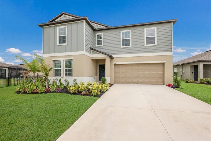 Front exterior of a new home in Seaire, Parrish, FL, highlighting curb appeal (Image 1). Front exterior of a new home in Seaire, Parrish, FL, highlighting curb appeal (Image 1).
