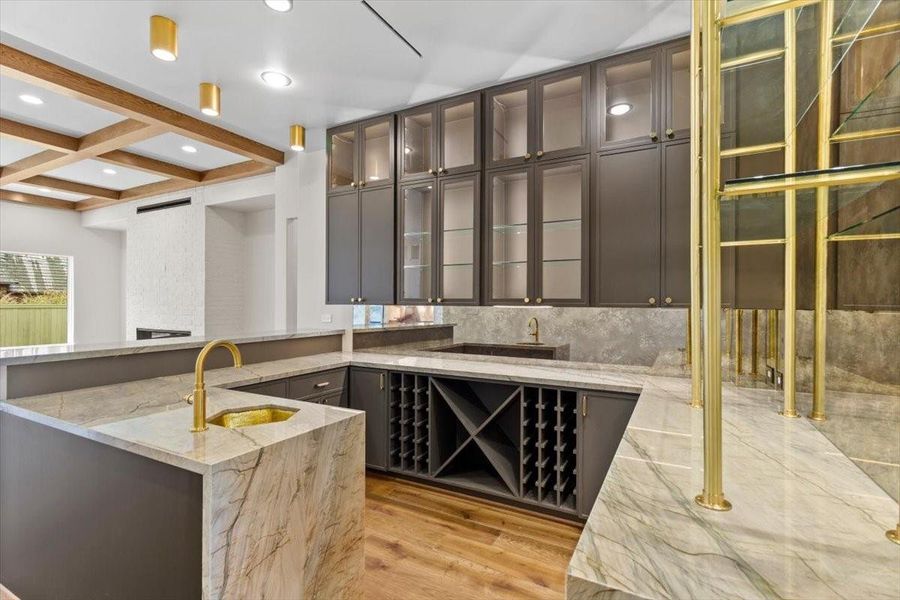 Brass under-mount sink along with waterfall stone slabs...this home is great for entertaining!