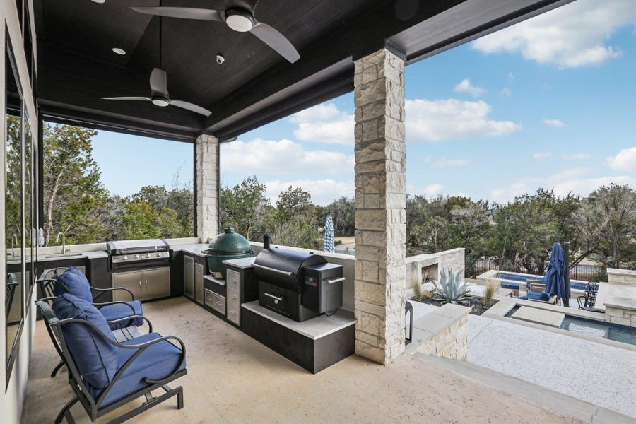 Host unforgettable barbecues with a fully equipped outdoor kitchen right on the patio. The outdoor setting includes ample patio space for dining, lounging, and enjoying the view.