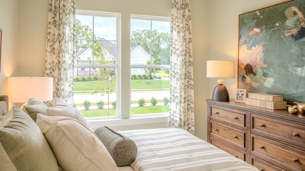 Secondary bedroom with carpet and bright natural light from windows Secondary bedroom with carpet and bright natural light from windows
