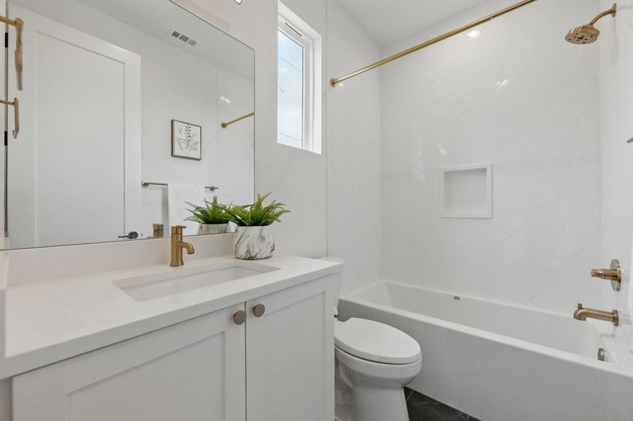 Bathroom featuring bathtub / shower combination and vanity Bathroom featuring bathtub / shower combination and vanity