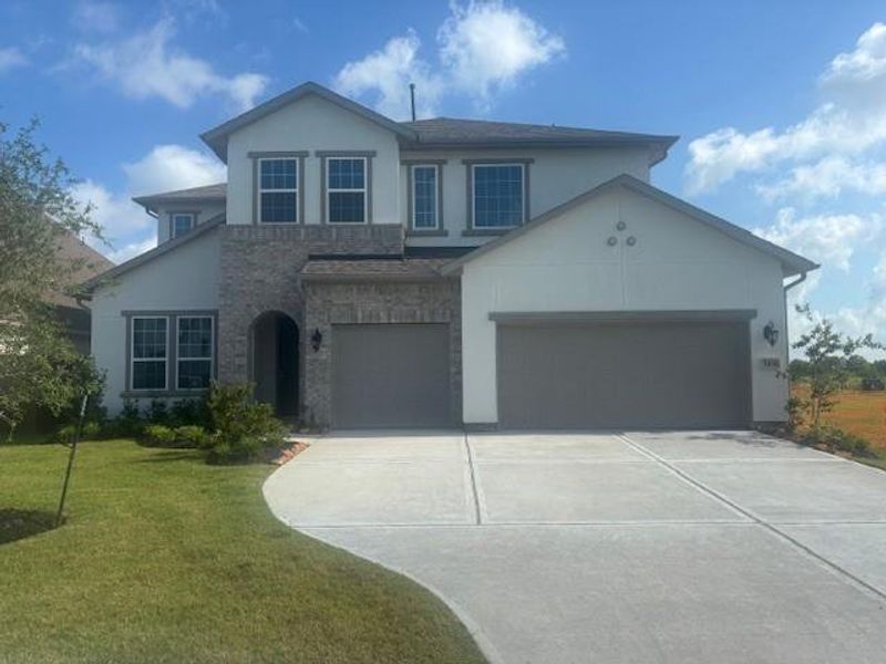 Front exterior of a new home in Del Bello Lakes 60', Manvel, TX, highlighting curb appeal (Image 2). Front exterior of a new home in Del Bello Lakes 60', Manvel, TX, highlighting curb appeal (Image 2).