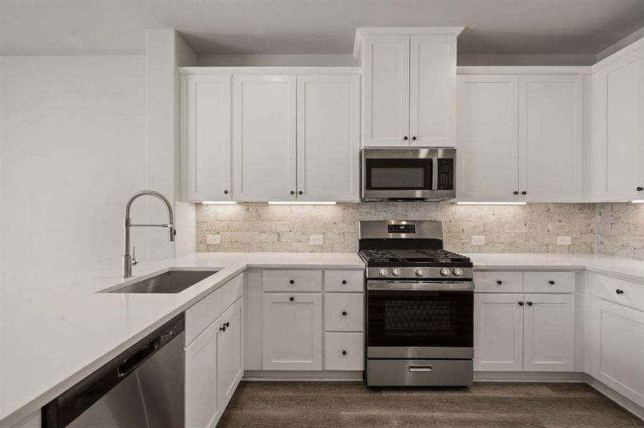 This beautiful kitchen offers crisp white cabinetry, gorgeous countertops and contemporary appliances artfully blended to create a dream kitchen!
