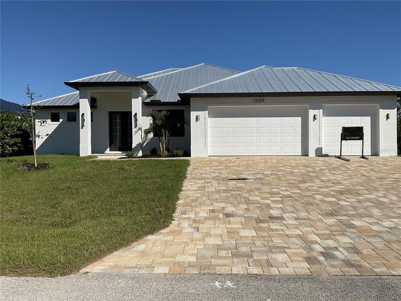 Front exterior of a new home in , Port Charlotte, FL, highlighting curb appeal (Image 1).