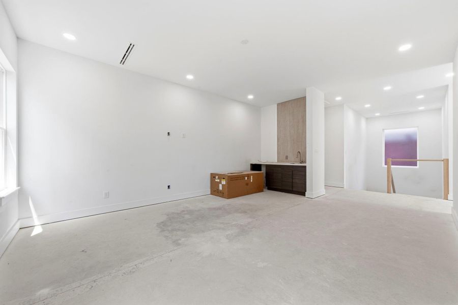 The game room will feature a porcelain-clad wall that flows with the downstairs finishes, complemented by custom shelving and a wine refrigerator. The game room will feature a porcelain-clad wall that flows with the downstairs finishes, complemented by custom shelving and a wine refrigerator.