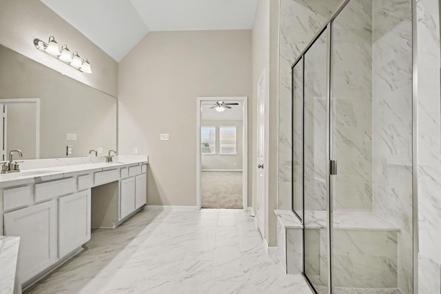 Over-sized walk-in shower with sitting ledge.