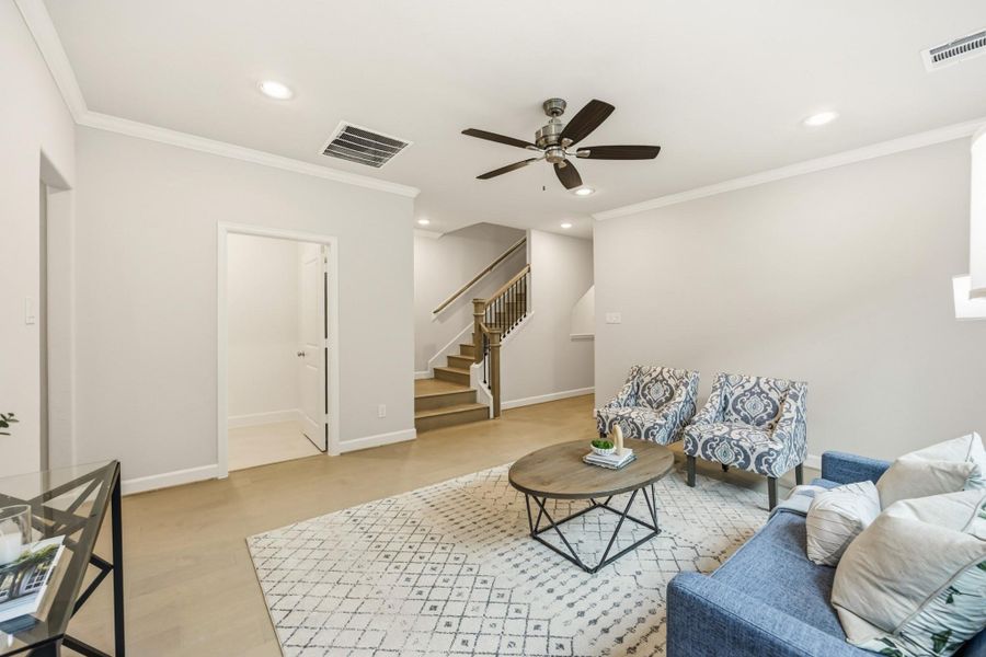 An alternate view of the game room shows a ceiling fan, access to the third level, and a journey down to the laundry room, defining multifunctional luxury. An alternate view of the game room shows a ceiling fan, access to the third level, and a journey down to the laundry room, defining multifunctional luxury.