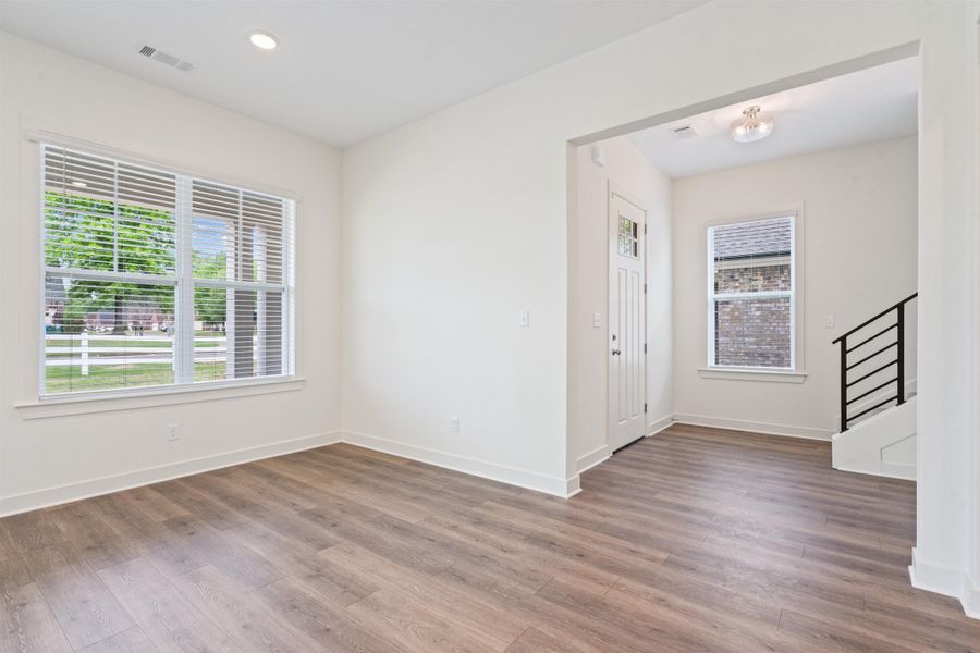 Entryway with wood finished floors and recessed lighting