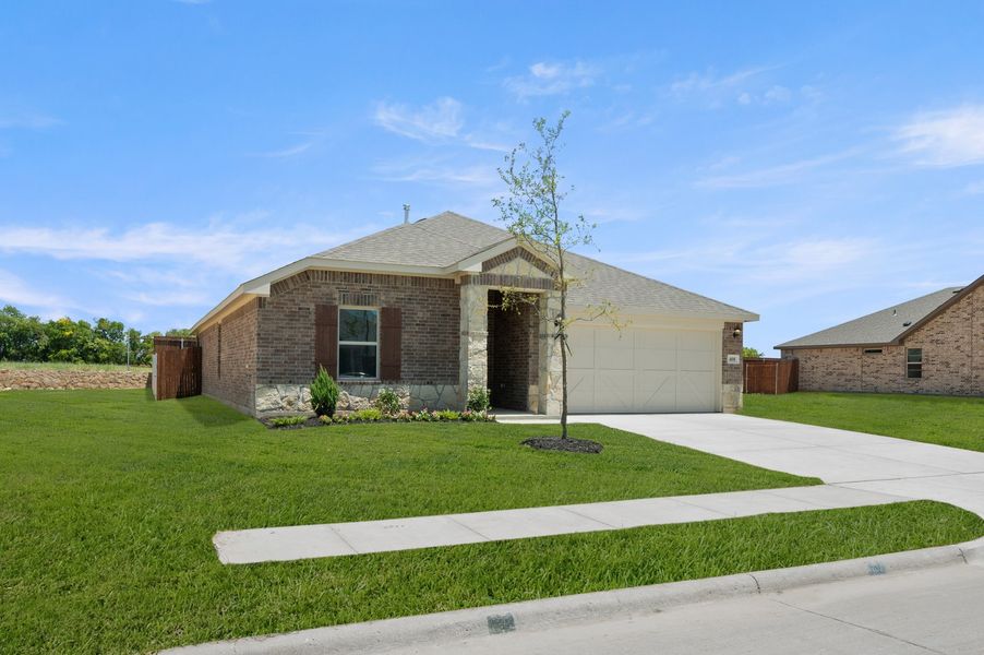 Front exterior of a new home in Baker Farms, Cleburne, TX, highlighting curb appeal (Image 2). Front exterior of a new home in Baker Farms, Cleburne, TX, highlighting curb appeal (Image 2).