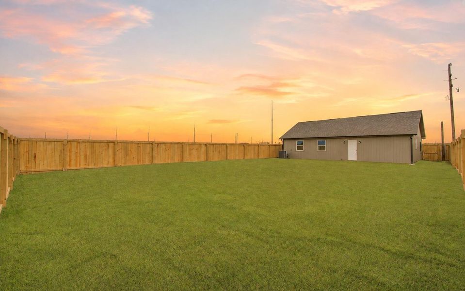 An expansive, fully fenced backyard with plenty of room to create your ideal outdoor retreat. (Sky Virtually Enhanced)