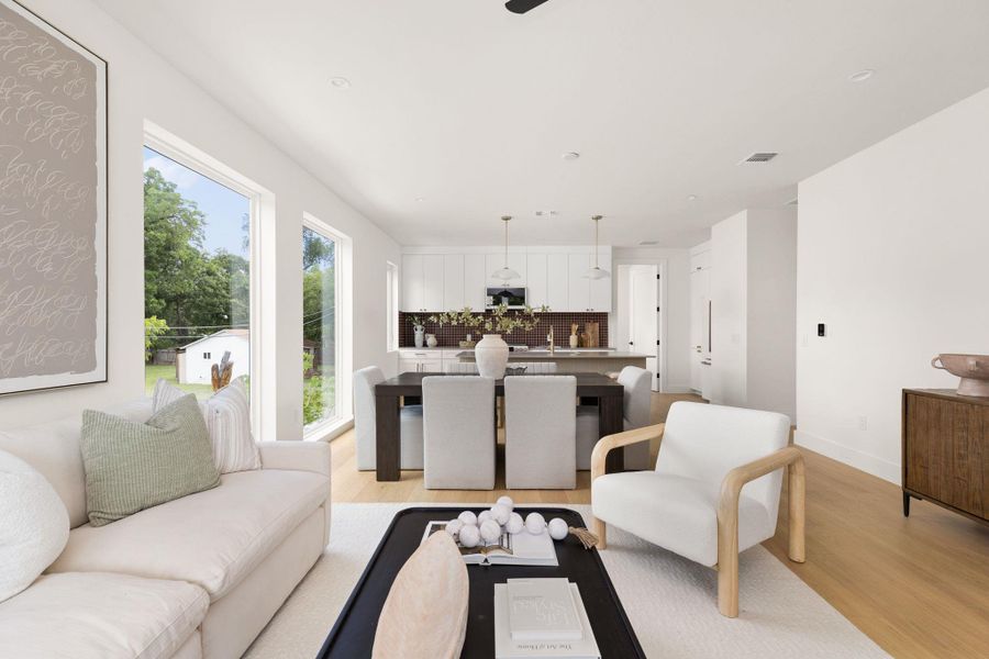 Natural light floods this inviting living space, connecting seamlessly to a contemporary kitchen with abundant cabinetry. Natural light floods this inviting living space, connecting seamlessly to a contemporary kitchen with abundant cabinetry.