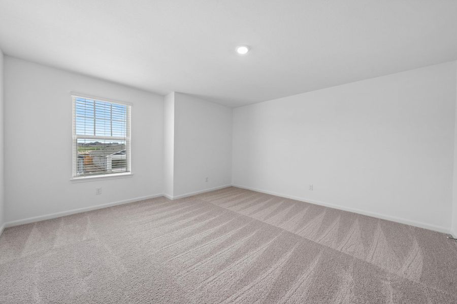 Unfurnished room with light carpet and baseboards Unfurnished room with light carpet and baseboards