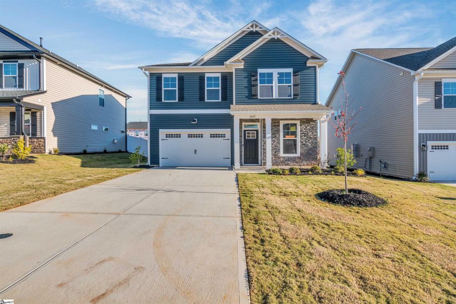 Front exterior of a new home in Halton Oaks, Spartanburg, SC, highlighting curb appeal (Image 18).