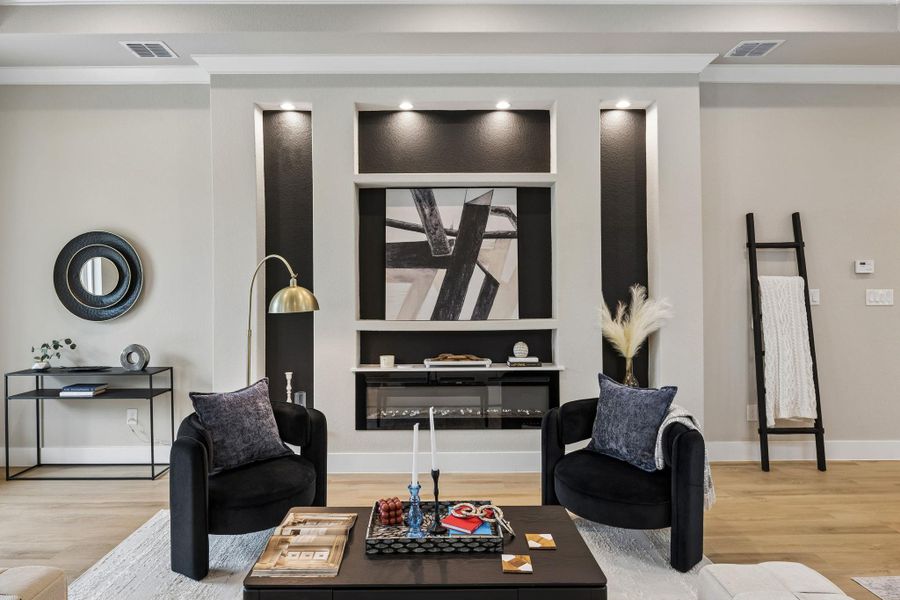 A refined living area boasts built-in features and an elegant electric fireplace for a modern aesthetic.