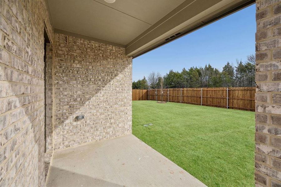 Covered Patio in the Heisman home plan by Trophy Signature Homes – REPRESENTATIVE PHOTO
