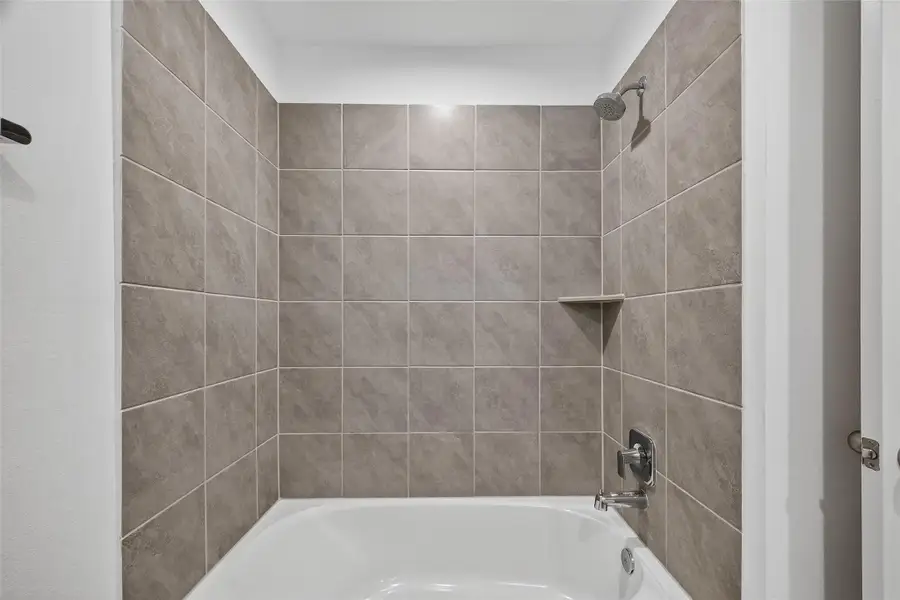 The secondary bathroom offers both style and convenience, featuring a tub and shower combo—perfect for guests or family members who prefer flexibility. The design is both functional and inviting, with clean finishes and ample space for daily routines. The secondary bathroom offers both style and convenience, featuring a tub and shower combo—perfect for guests or family members who prefer flexibility. The design is both functional and inviting, with clean finishes and ample space for daily routines.