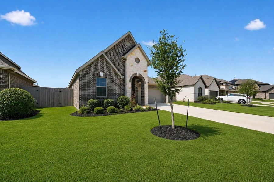 Front exterior of a new home in Oakwood Estates, Waller, TX, highlighting curb appeal (Image 1). Front exterior of a new home in Oakwood Estates, Waller, TX, highlighting curb appeal (Image 1).