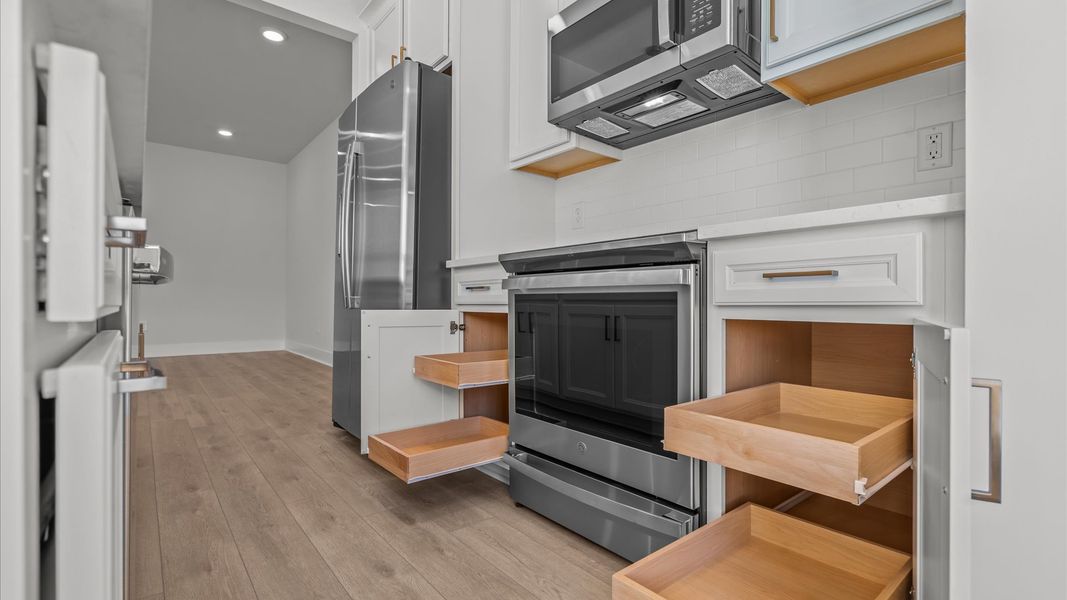 Exclusive DRB Homes kitchen with a 9-foot island, elevated finishes, and pendant lighting in a prime location