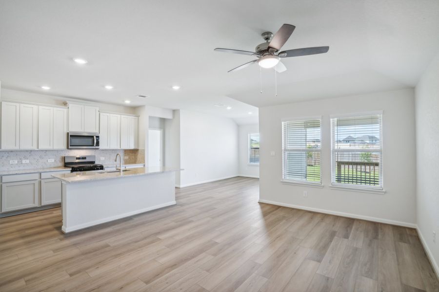 Kitchen, living room, and dining room in the Callaghan floorplan at a Meritage Homes community.