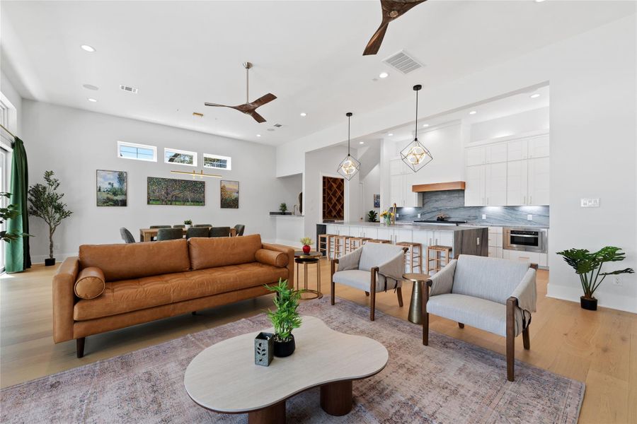 Designed for effortless entertaining, the spacious great room offers multiple gathering areas, designer lighting, and a seamless transition between indoor living and the surrounding outdoor spaces. Designed for effortless entertaining, the spacious great room offers multiple gathering areas, designer lighting, and a seamless transition between indoor living and the surrounding outdoor spaces.
