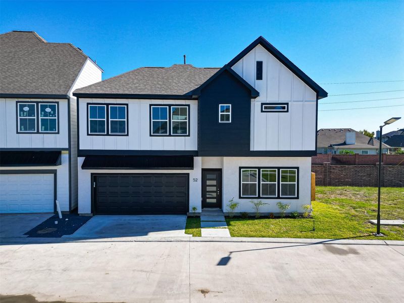 Front exterior of a new home in Metro Village, Houston, TX, highlighting curb appeal (Image 1).