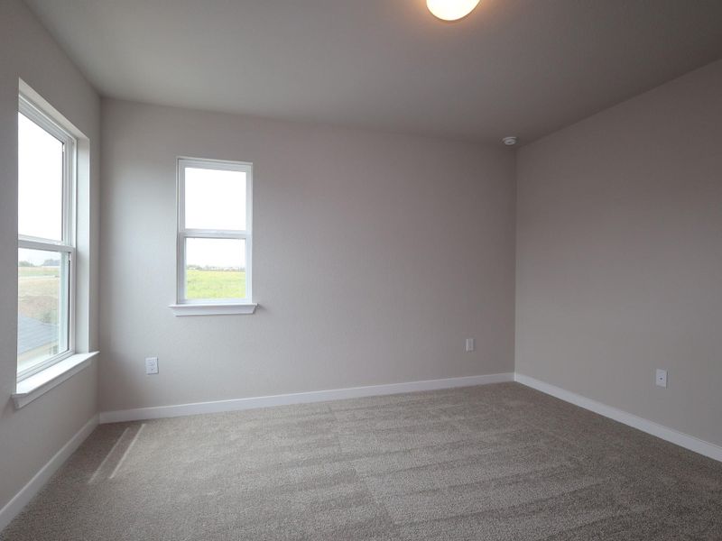 A quiet retreat with plush carpeting awaits, offering serene views through generous windows.