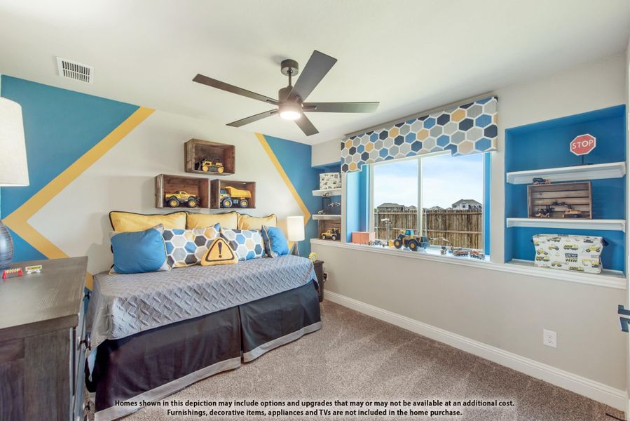 Children's bedroom with blue accent walls, built-in shelves, ceiling fan, and construction-themed decor