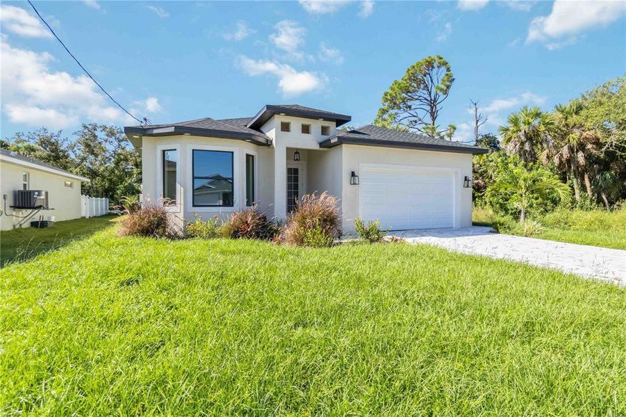 Front exterior of a new home in , Rotonda West, FL, highlighting curb appeal (Image 17).