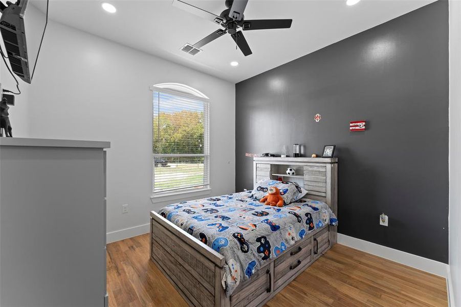 Bedroom featuring wood finished floors, a ceiling fan, and recessed lighting Bedroom featuring wood finished floors, a ceiling fan, and recessed lighting