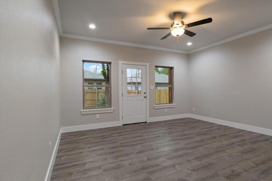 Unfurnished room featuring ornamental molding, ceiling fan, and hardwood / wood-style floors