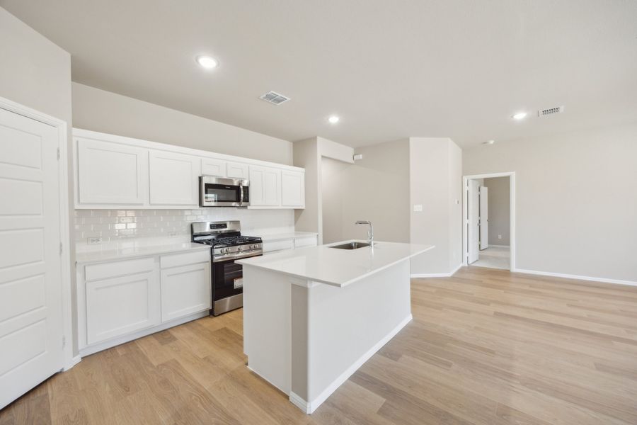 Kitchen in the Harper home plan by Trophy Signature Homes – REPRESENTATIVE PHOTO