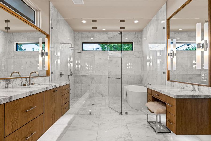 Bathroom featuring healthy amount of natural light, a freestanding tub, a stall shower, and tile walls Bathroom featuring healthy amount of natural light, a freestanding tub, a stall shower, and tile walls