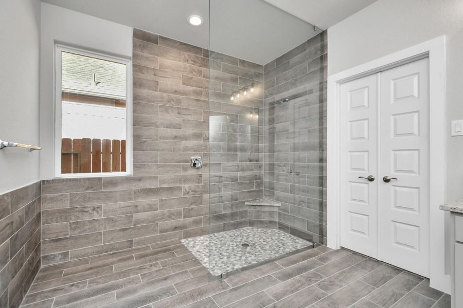 Enjoy a massive walk-in shower with tile surround. Sample photo of completed home with similar plan. As built color and selections will vary. Enjoy a massive walk-in shower with tile surround. Sample photo of completed home with similar plan. As built color and selections will vary.