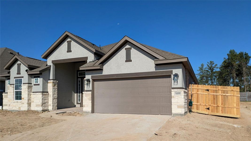 Front exterior of a new home in Artavia, Conroe, TX, highlighting curb appeal (Image 17). Front exterior of a new home in Artavia, Conroe, TX, highlighting curb appeal (Image 17).