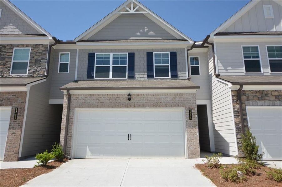Front exterior of a new home in Somerset at Riverbrook, Gainesville, GA, highlighting curb appeal (Image 1). Front exterior of a new home in Somerset at Riverbrook, Gainesville, GA, highlighting curb appeal (Image 1).