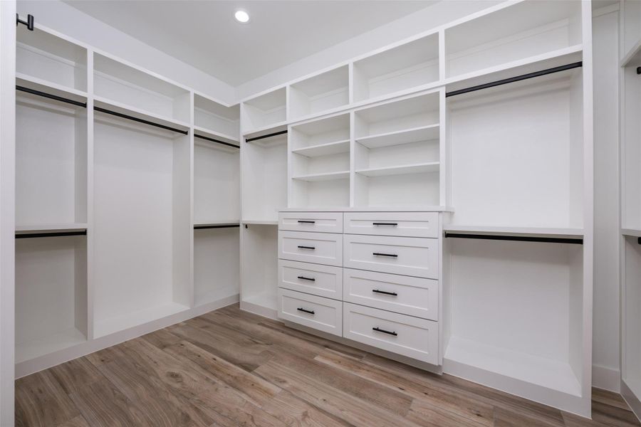 Spacious closet with light hardwood / wood-style floors