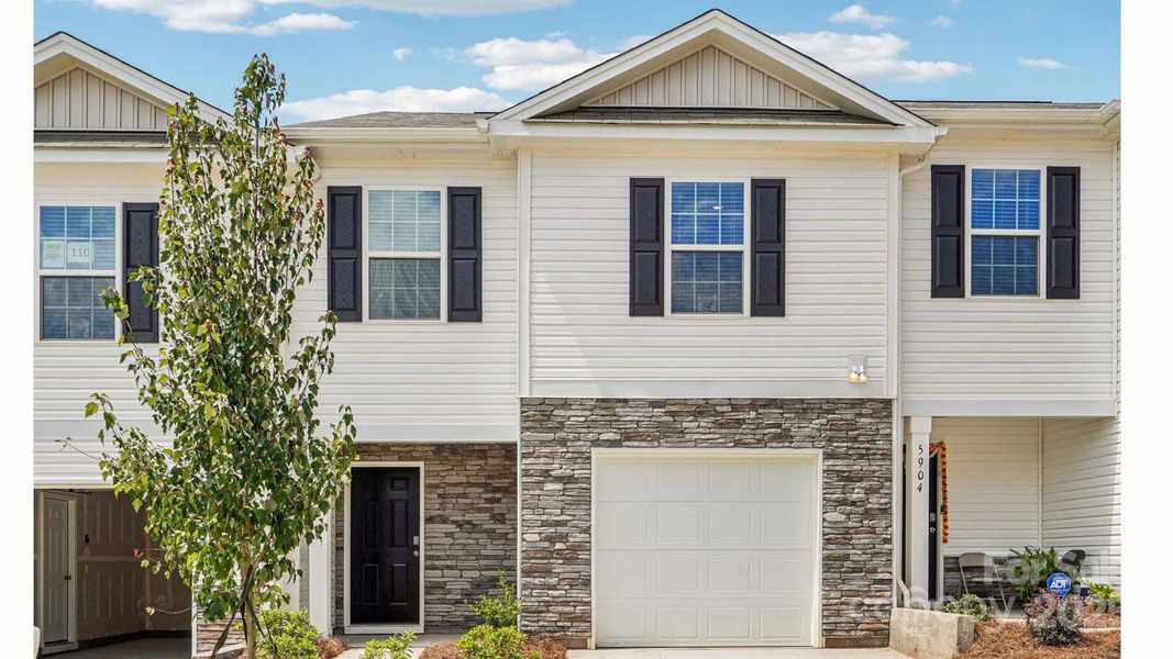 Front exterior of a new home in Mallard Creek Townhomes, Charlotte, NC, highlighting curb appeal (Image 1). Front exterior of a new home in Mallard Creek Townhomes, Charlotte, NC, highlighting curb appeal (Image 1).