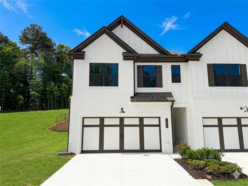 Front exterior of a new home in Millstone at Mundy Mill, Gainesville, GA, highlighting curb appeal (Image 1). Front exterior of a new home in Millstone at Mundy Mill, Gainesville, GA, highlighting curb appeal (Image 1).