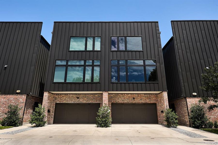 View of front of property with an attached garage, concrete driveway
