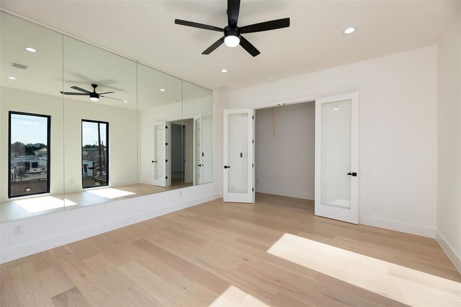 Unfurnished bedroom with recessed lighting, light wood-style flooring, french doors, a ceiling fan, and access to outside Unfurnished bedroom with recessed lighting, light wood-style flooring, french doors, a ceiling fan, and access to outside