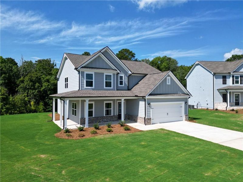 Front exterior of a new home in Harmony Farms, Eatonton, GA, highlighting curb appeal (Image 24). Front exterior of a new home in Harmony Farms, Eatonton, GA, highlighting curb appeal (Image 24).