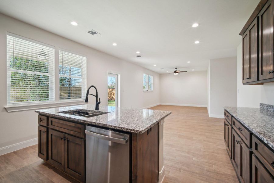 Kitchen featuring a sink, dark brown cabinetry, recessed lighting, and stainless steel dishwasher Kitchen featuring a sink, dark brown cabinetry, recessed lighting, and stainless steel dishwasher